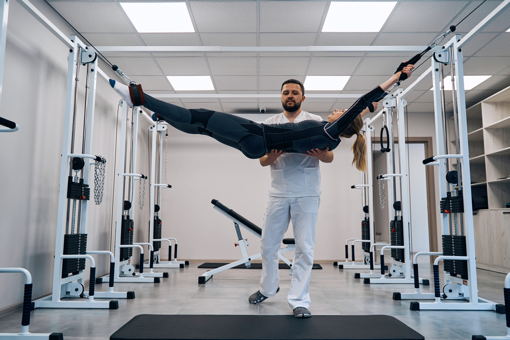 Strength training of young woman on decompression simulator
