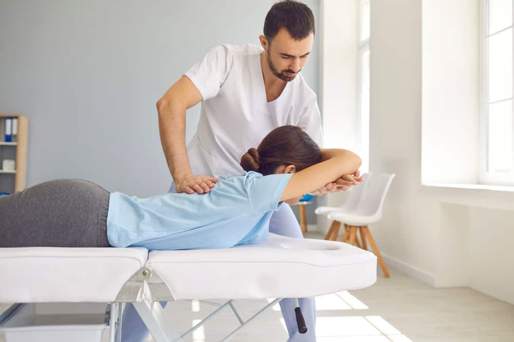 Woman having chiropractic back adjustment.
