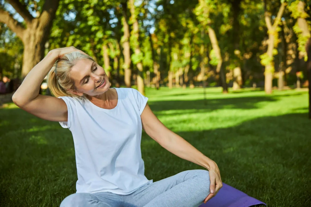 Woman performing neck stretches to improve long-term neck health