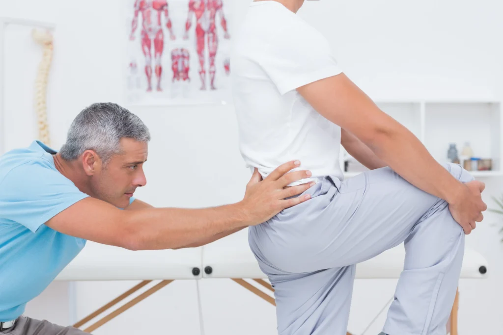 doctor examining his patient back - How Long Does Sciatica Last Without Treatment? - Apex Chiropractic