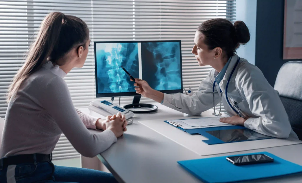 Patient consulting with doctor for severe sciatica symptoms.