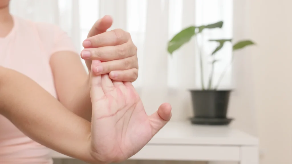 Person performing self-massage on the wrist