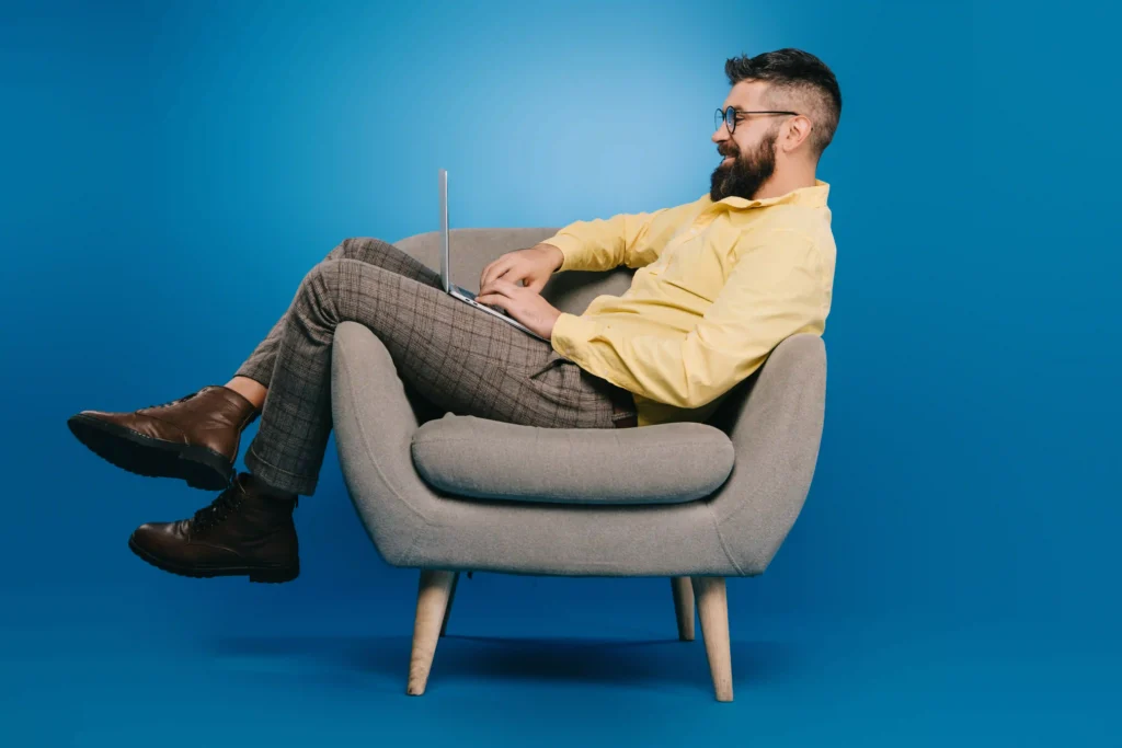 Person sitting in a poor posture while working on a laptop