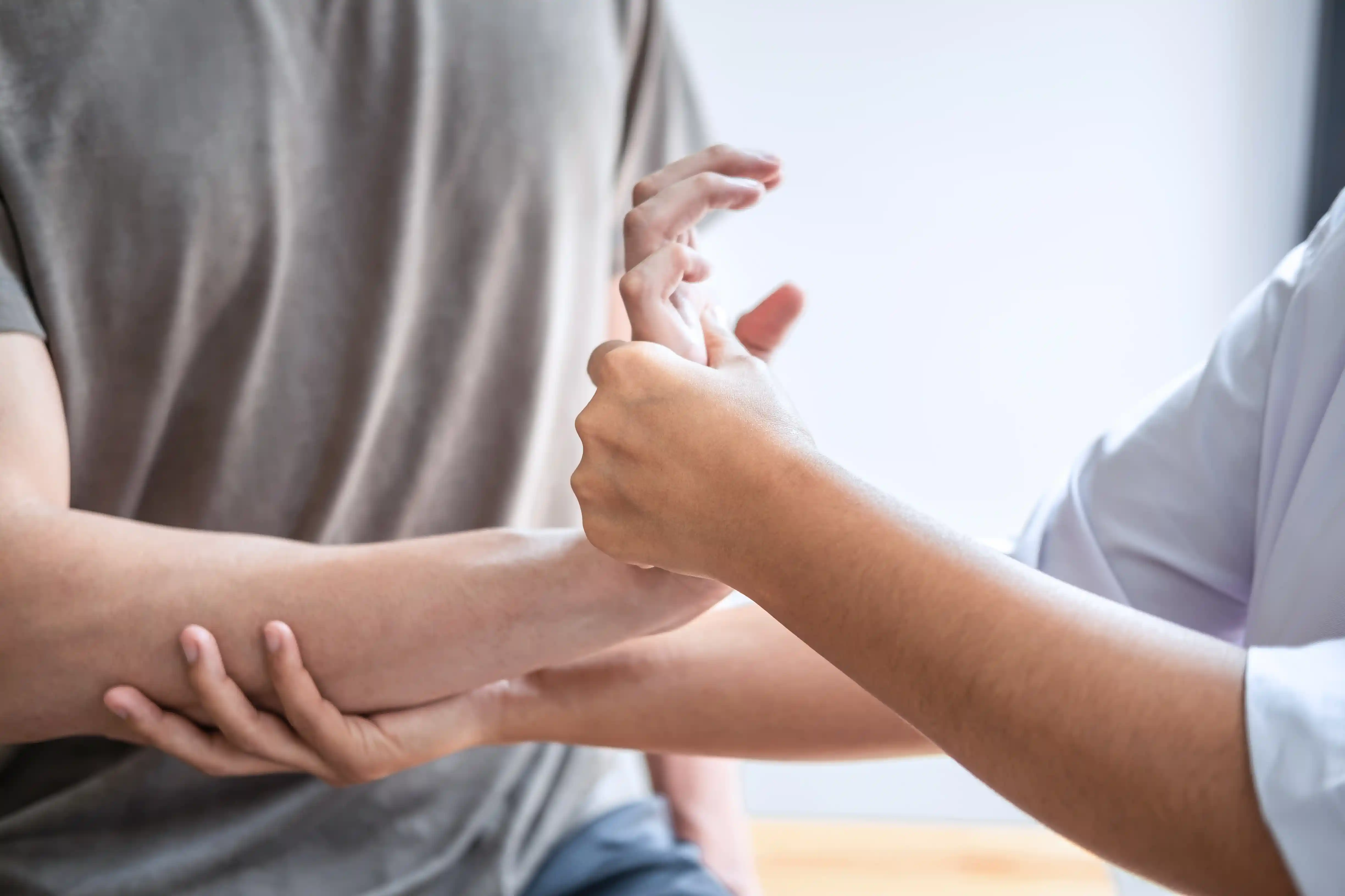Chiropractor providing wrist care in a clinic