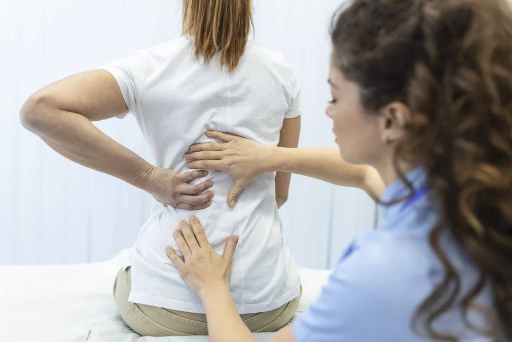 physiotherapist doing healing treatment womans back back pain patient treatment medical doctor massage therapistoffice syndrome - How Long Does Sciatica Last Without Treatment? - Apex Chiropractic