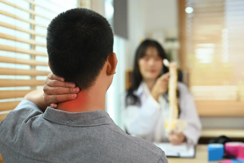 Man with stiff Neck and Pain Consults with a Doctor
