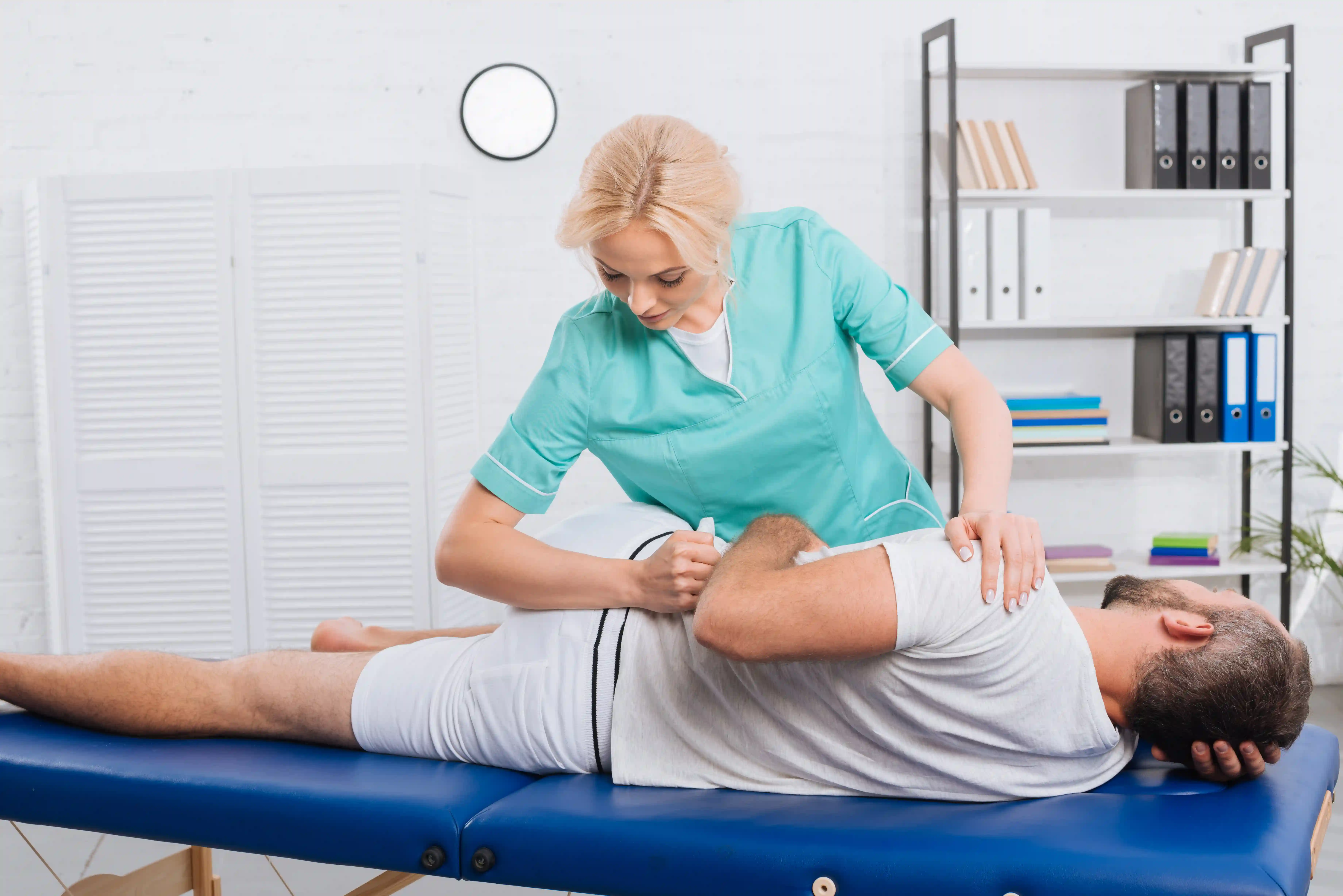 Chiropractor performing a lower-body or pelvic adjustment