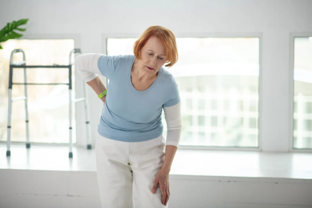 Older woman experiencing knee and hip joint pain