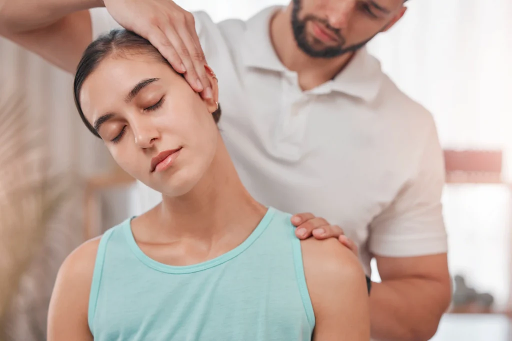 Therapist providing neck and shoulder massage.
