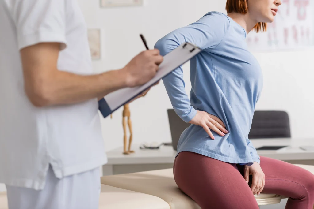 Chiropractor consulting with a patient in a clinic